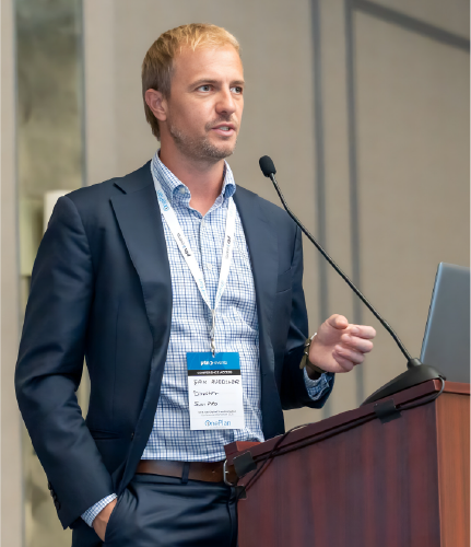 Conference speaker presenting on stage at DTC 2027